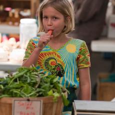 Amherst Farmers' Market child enjoys fresh carrot