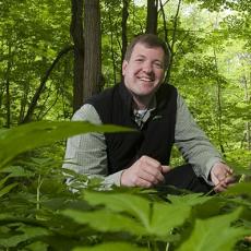 Randall Prostak identifies weeds in the forest