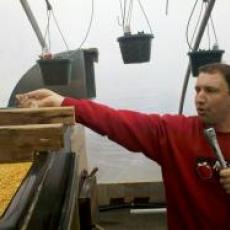 Farmer Dave showing off his corn furnace at a twilight meeting