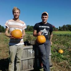 UMass students Neev Blume and Cole Lanier offer tour of pumpkin patch at SFE