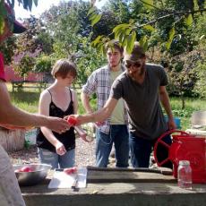 GardenShare student farmer, Jake Harness, makes fresh apple cider