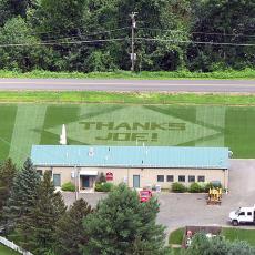 Aerial view of a lawn design reading ‘THANKS JOE!’ in honor of Dr. Joseph Troll, a longtime leader in the Turf Program at UMass and the Center’s namesake