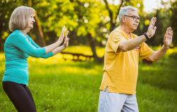 older couple doing tai chi