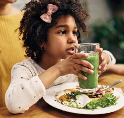 young girl with green drink