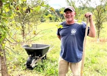 Scott Hathaway, Westfield tree warden and SSA graduate, helps maintain growing elms on Dakin Frield at UMass Amherst